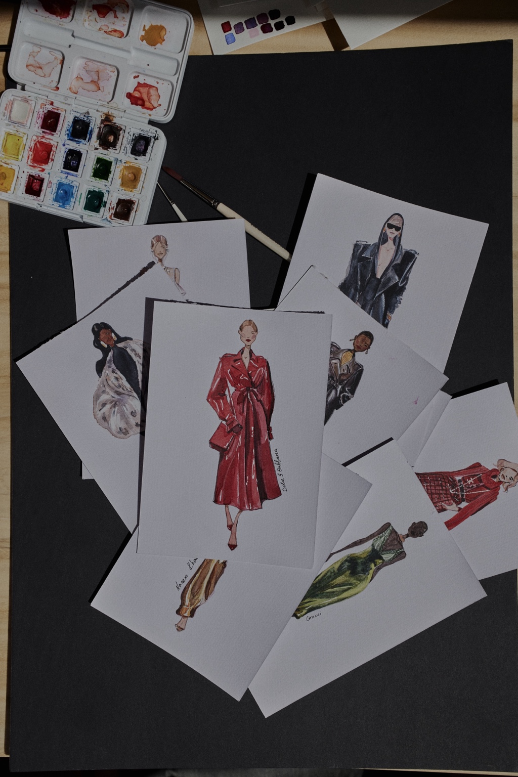 A collection of Nataliia's hand-painted fashion figures and runway looks